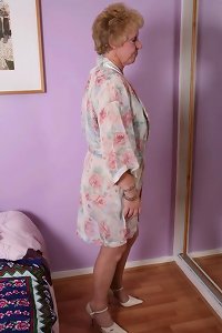 a blonde old lady is giving a man's ass with her large tits