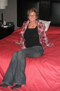 a woman in stockings playing with a cock and panties